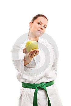 Young girl wearing kimono and offering an apple