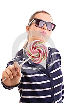 Young girl wearing sunglasses and holding a lollipop