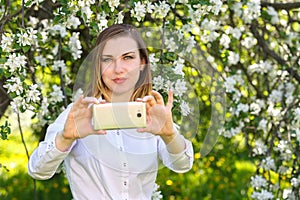 Young girl takes selfie on smartphone