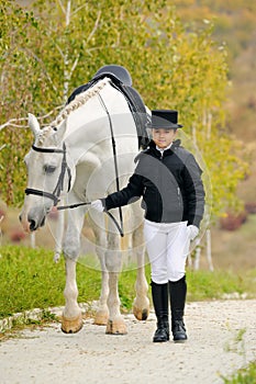 Young girl with white dressage horse