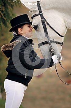 Young girl with white dressage horse