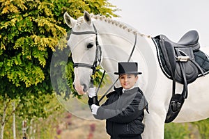 Young girl with white dressage horse