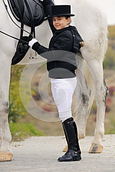 Young girl with white dressage horse