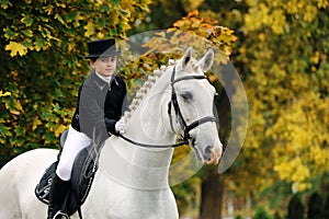 Young girl with white dressage horse