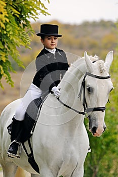 Young girl with white dressage horse