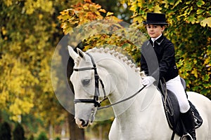 Young girl with white dressage horse