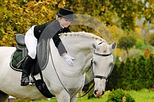 Young girl with white dressage horse