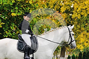 Young girl with white dressage horse