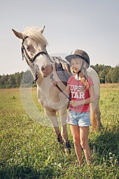 A young girl and white pony horse