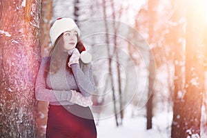 A young girl in a winter park on a walk. Christmas holidays in t
