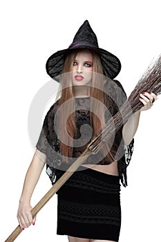 Young girl in witch costume with a broom