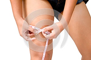 Young Girl Woman her Leg with a Metric Tape measure. Standing Si