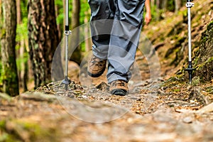 Young girl woman Hiking schoes and sticks detail view in the forest outdoor activity in nature