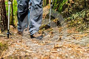 Young girl woman Hiking schoes and sticks detail view in the forest outdoor activity in nature