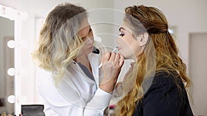 Young girl/woman making makeup in dressing makeup room.