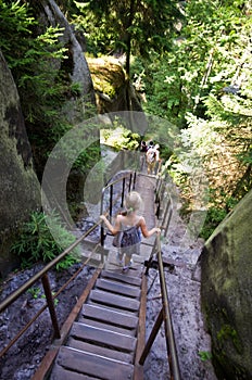 Young girl on wooden stairs, Rock Town Park, Adrspach Teplice, Czech Republic