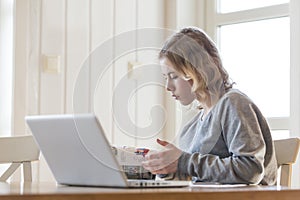 Young girl working on a laptop