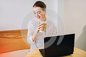 Young girl working on laptop in a cafe.