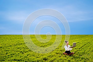 Young girl working with laptop, tablet and phone