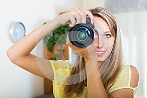 Young girl working with photocamera