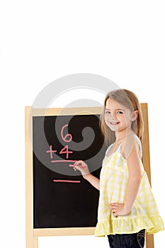 Young Girl Writing On Blackboard