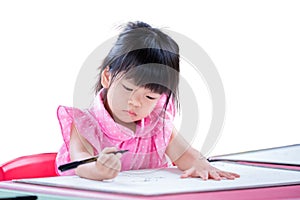 Young Girl 3 years old Focused on Drawing at Home, A little child in a pink dress intently drawing on a white paper.