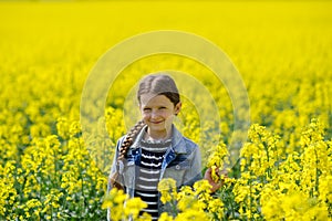 Young girl on a yellow field