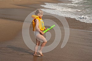 Young girl with yellow life jacket.