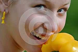 Young girl with yellow pepper