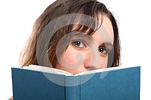 Young girls beautiful green eyes reading a book