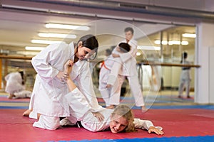 Young girls and boys exercising karate movements