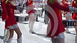 Young girls drummer in red at the parade. Street performance on the occasion of the holiday