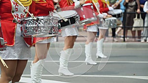 Young girls drummer in red vintage uniform at the parade. Street performance. Parade of majorettes