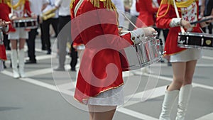Young girls drummer in red vintage uniform at the parade. Street performance. Parade of majorettes