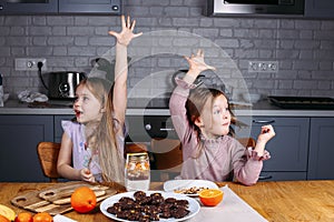 Young girls eating biscuits at home photo