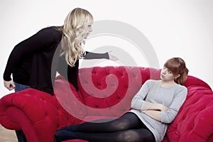 Young girls have a fight on red sofa