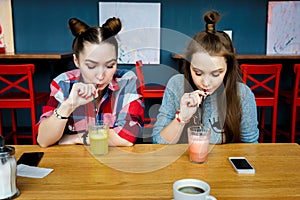 Young girls having fun in a cafe bar photo