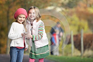 Young Girls Listening To MP3 Player Outdoors photo