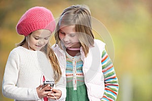 Young Girls Outdoors With MP3 Player photo