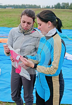 Young girls-parachutists examine gloves