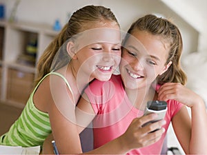 Young Girls Playing With A Cellphone