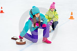 Young girls playing curling