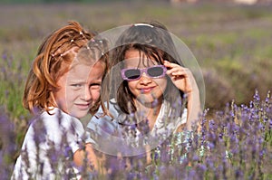 Young girls plays in a field of flowers