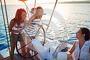 Young girls sailing on boat together and enjoy at sunset on vacation