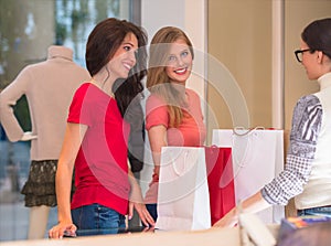 Young girls with shopping bags in store