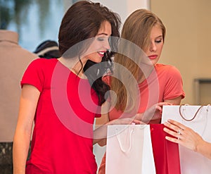 Young girls with shopping bags in store