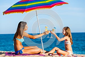 Young girls on summer holiday with cocktails.