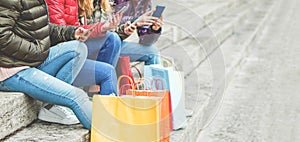 Young girls using smartphone web app for shopping online - Millennials women having fun with mobile phones - New female technology