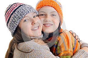 Young girls in warm winter clothes hugging