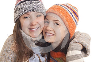 Young girls in warm winter clothes hugging